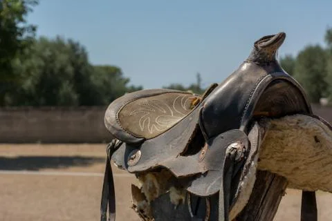 Close Up of Old Saddle on Blur Background in a Sunny Day Stock Photos