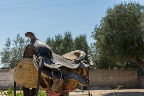 Close Up of Old Saddle on Blur Background in a Sunny Day Stock Photos