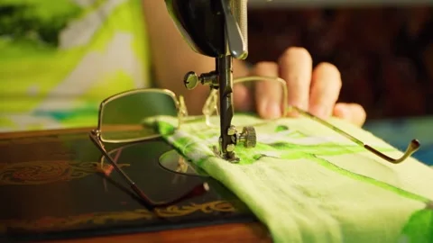 Close-up of an old sewing machine with brightly colored fabric. Stock Footage 255814077