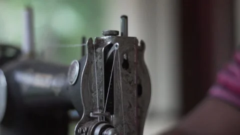 Close up of old sewing machine with women's hands on table slow motion Video stock 130851063
