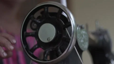Close up of old sewing machine with women's hands on table slow motion Video stock 130851458
