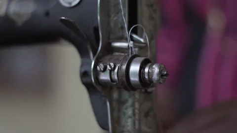 Close up of old sewing machine with women's hands on table slow motion Stock Footage 130853831