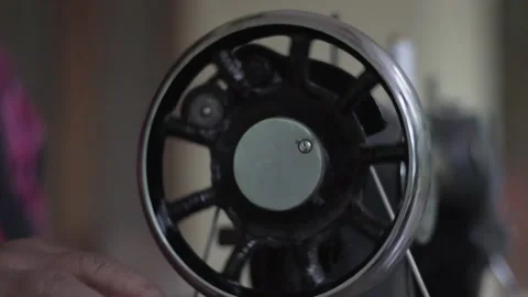 Close up of old sewing machine with women's hands on table slow motion Video stock 130854610
