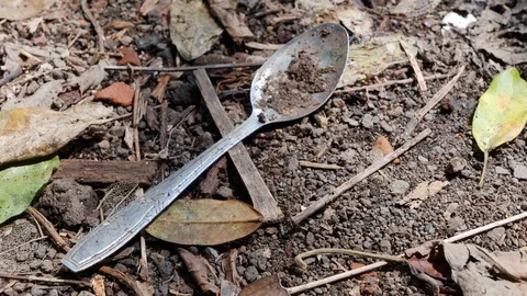 Close up of old spoon on ground, remains of traditional burial, Trunyan, Bali Stock Footage 140271499