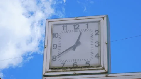 Close-up of old square city clock against the blue sky Stock-Footage 96803631
