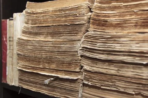 Close-up of old stacked paper documents with yellowed edges on shelf Stock Photos
