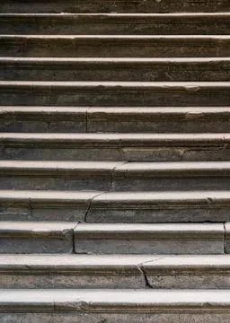 Close up of old stone steps with cracks and weathered texture. Ideal as backg Stock Photos