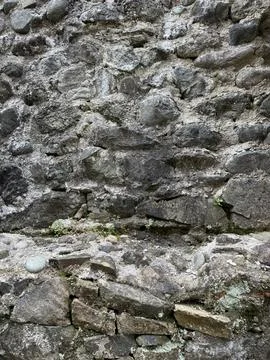 Close-up of an old stone wall with visible mortar and natural erosion Stock Photos