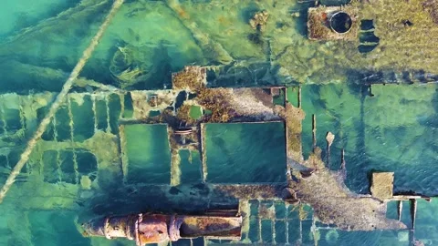 Close up of old stranded ship after crash lying in the blue sea. Aerial view Stock-Footage 138594206