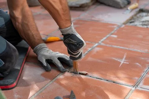 Close up of old tile removal with a chisel during terrace or floor renovation 写真素材