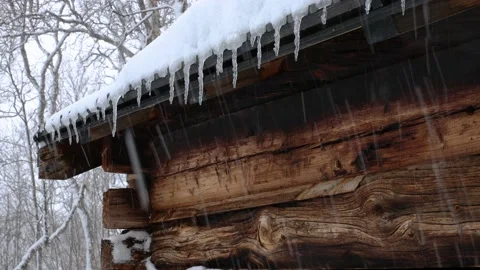 Close-up of old timber building with dripping icicles from the roof Stock Footage 238520374