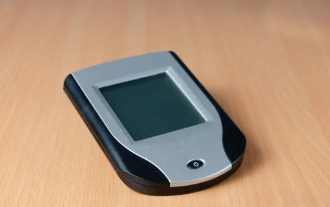 Close-up of old touchscreen  personal digital assistent (PDA) on wooden  back Stock Photos