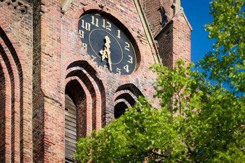 Close up of old tower clock on red brick church Stock Photos