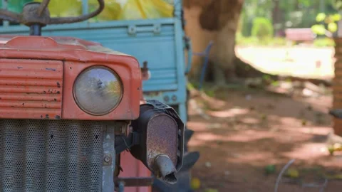 Close-up of old tractor headlight and grille outdoors Stock Footage 326150059
