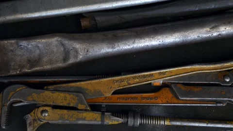 Close-up of Old Used Adjustable Gas Wrench on Steel Table in Garage Workshop Stock Footage 144010512