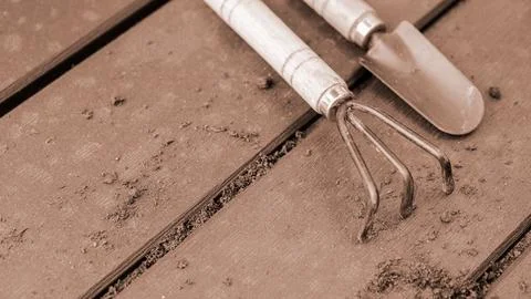Close up of old used garden tools shovel and rake, Colour of the year Mocha.. Stock Photos