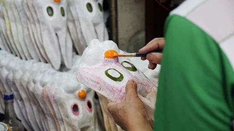 Close up of old vietnamese man hand painting noses on bunny masks in hanoi Stock-Footage 147373222