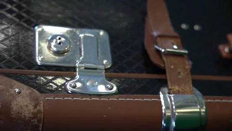 Close-up of an old vintage leather suitcase with straps and buckles Stock Footage 245230750