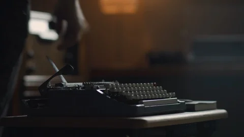 Close up of an old vintage typewriter, a man sits down at it to begin to write Stock Footage 97871768
