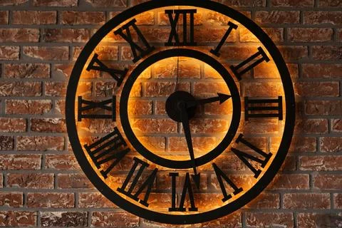 Close up old vintage wall clock over background of grunge brick wall Stock Photos