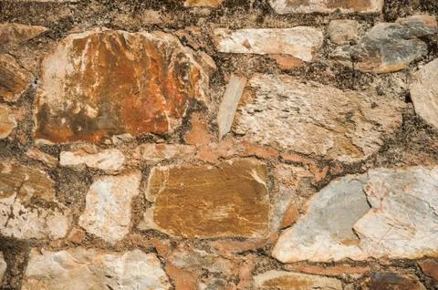 Close-up of old wall made of rough stones forming a charming background at Ca Stock Photos