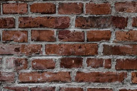 Close-up of old wall with red bricks and concrete. Abstract background texture. Stock Photos