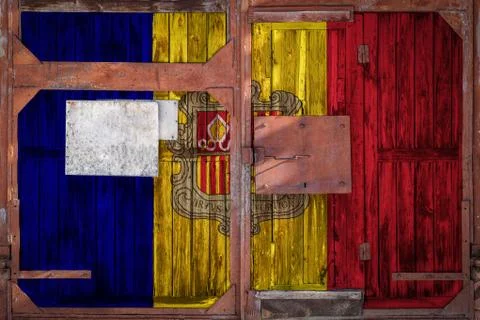 Close-up of old warehouse gate with national flag of Andorra. The concept of  库存照片