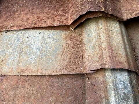 Close-up of old, weathered, and heavily rusted corrugated iron sheets Stock Photos