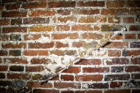 Close up of old weathered bricks outside in dark reds Stock Photos