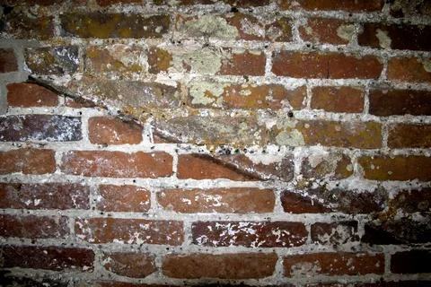 Close up of old weathered bricks outside in dark reds Stock Photos
