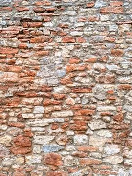 Close up of old weathered bricks outside in dark reds Stock Photos