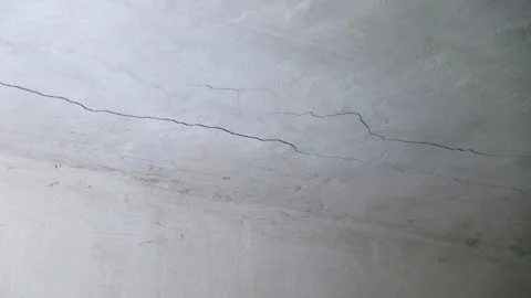 Close up. Old white abandoned cement ceiling with cracks and cobwebs. Video stock 294048343