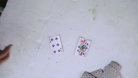 Close-up of old white table where old men playing cards outside Stockbeeldmateriaal 134402335