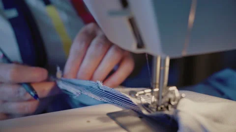 Close-up, Old Woman's Hands Draw a Tag on The Matter for Sewing on a Sewing Stock Footage 136379533