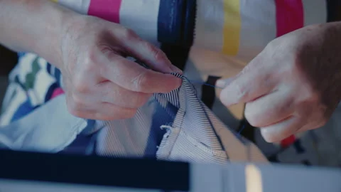 Close-up, Old Woman's Hands Make a Scree on The Matter for Dresses Stock Footage 136441412