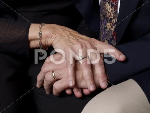 Close up of older couple's clasped hands Stock Photos
