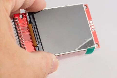 Close-up of an OLED display for microcontroller devices held in a hand. Stock Photos