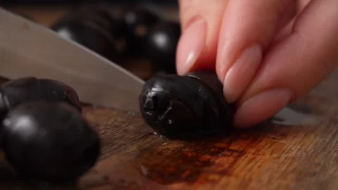 Close-Up of Olive Slicing on Board. Stock Footage 256185746