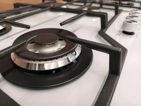 Close up of one burner on white built in gas cooker showcased in a construc.. Фото