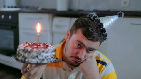 Close Up One Depressed Man Holding Birthday Cake Looking At Camera Stock-Footage 334042901