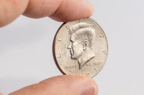 Close-up of a one-dollar coin in a hand. Stock Photos