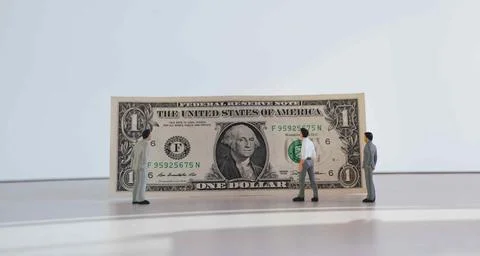 Close up of one dollar isolate on white background. Miniature people Stock Photos