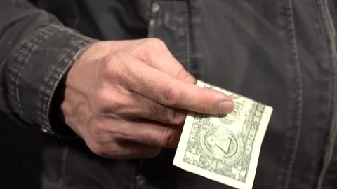 Close-up of a One Dollar in a Man's Hand in a Work Jacket. Put your Money in Stock Footage 147981510