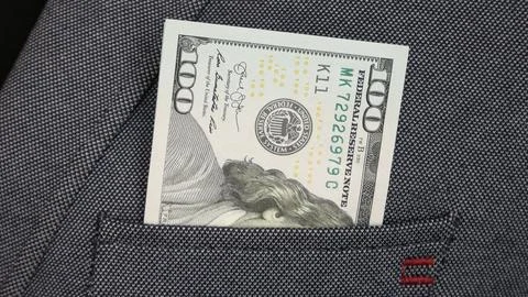 Close-up of one hundred dollar bill in somebody's blazer pocket Stock Photos
