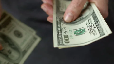 Close-up of one hundred dollar bills. American dollars are counted in hands. Stock Footage 222924083