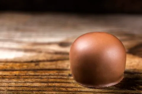 Close up of one round candy over wood with copy space Stock Photos