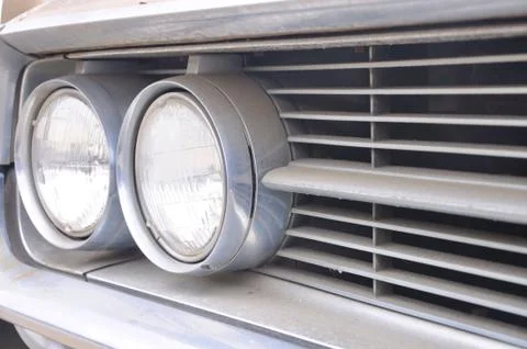 Close up of one side of double round headlights on an old classic car Stock Photos