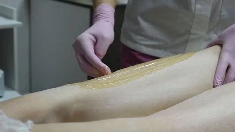 Close-up of one of the stages of the procedure for removing hair on the legs Stock Footage 118705591