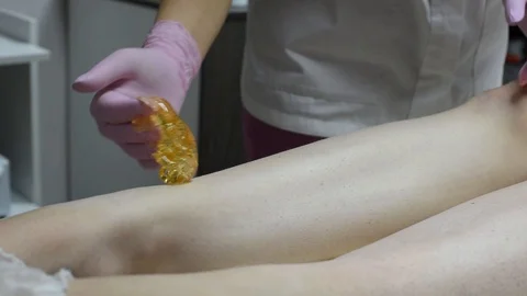 Close-up of one of the stages of the procedure for removing hair on the legs Stock Footage 118705594
