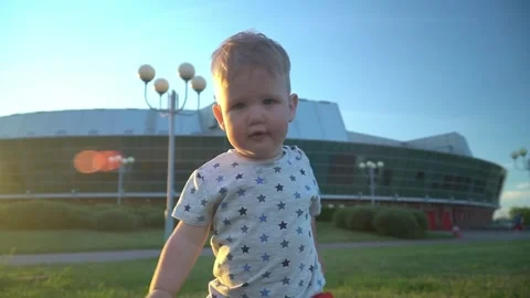 Close-up of a one-year-old boy running through a summer park in front of the cam Stock Footage 308815912